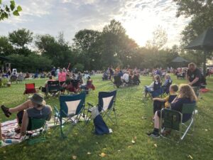 people sit in a park listening to music in Windsor Heights